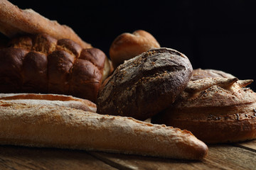 Assortment of fresh bread on a wooden background