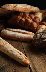 Assortment of fresh bread on a wooden background