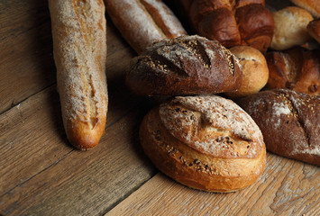 Assortment of fresh bread on a wooden background