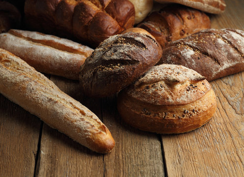 Assortment of fresh bread on a wooden background