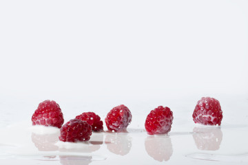 Raspberries Falls Into Milk