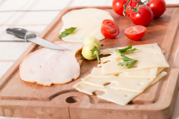 Fototapeta na wymiar Delicious Meat And Cheese Slices With Tomatoes