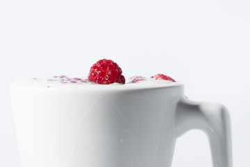 Raspberries Falls Into Milk