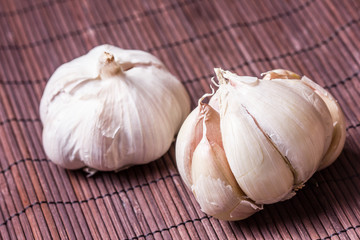 Garlic on violet bamboo mat.