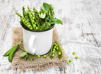 Metal cup with fresh peas