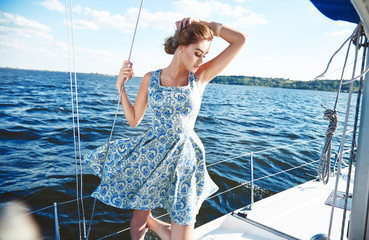 Beautiful sexy brunette girl in dress makeup summer trip yacht