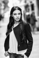 Hispanic young woman wearing casual clothes in urban background