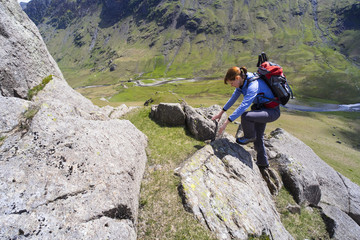 Climber scrambling up Cam Ridge