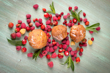 muffins, scattered around the raspberries, strawberries, mint le