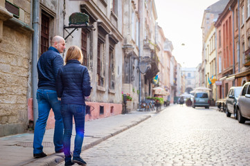 Obraz na płótnie Canvas Young fashion elegant stylish couple walk on streets of european city in summer morning