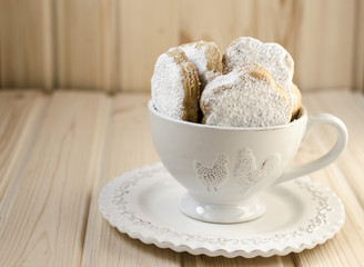 Spanish cookies for fat in a cup with a bouquet of roses 