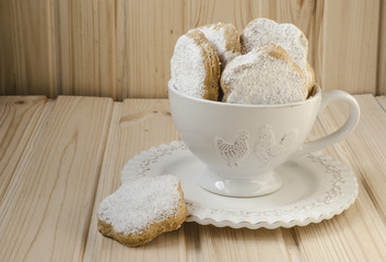 Spanish cookies for fat in a cup with a bouquet of roses 