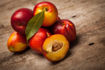 Fototapeta na wymiar fresh peaches on wooden table