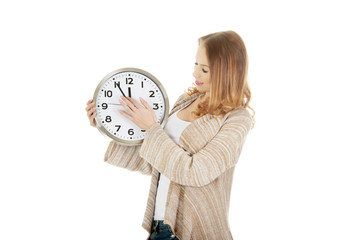 Woman changes clock leads.