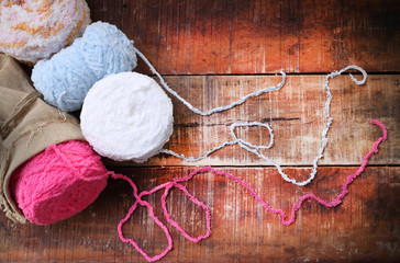 Colorful yarn balls on a wooden background room for copy space  vintage style