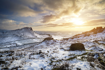 Stunning Winter sunset over countryside landscape with dramatic