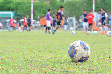 blurred background kid soccer player in academy