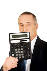 Happy businessman holding a calculator