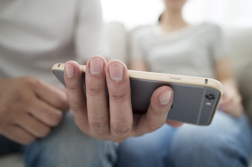 Men and women are looking at smartphone together