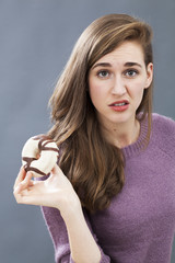 dubious young girl questioning junk food or sweet food as unhealthy diet - obrazy, fototapety, plakaty