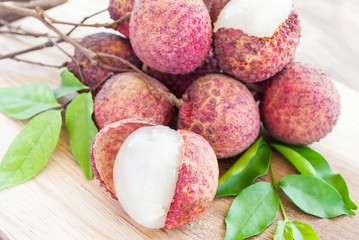 Closeup of lychee fruits on wooden board, fruits of asian