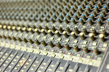 An Audio mixing table in soft light