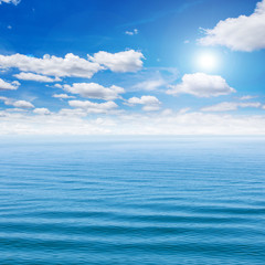 Naklejka na ściany i meble Sea and blue sky with sun