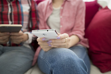 Two women sitting looking at the smartphone
