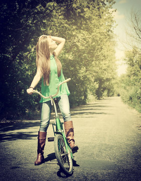 Happy smiling young beautiful woman with retro bicycle, summer o
