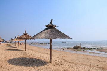 Grass umbrellas at the beach