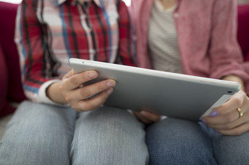 Two women looking at the tablet