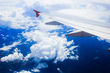 Fototapeta na wymiar Plane wing with beautiful cloud