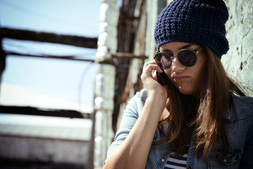 Fototapeta premium Teen girl calling smart phone outdoor. Teenage problem. Image to