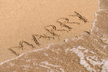 Marry Me Word Written On Sunny Summer Beach Sand
