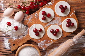 preparation of sweet dumplings with cherries. Horiozntal top view
