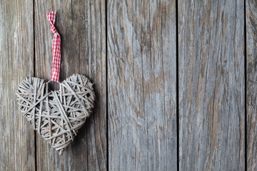 Red hearts hanging over old wood background