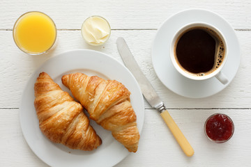 Coffee, orange juice and croissant breakfast. From above.