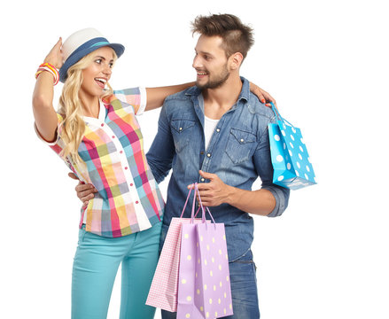 Young, smiling couple on a shopping spree. Shallow DOF, focus on