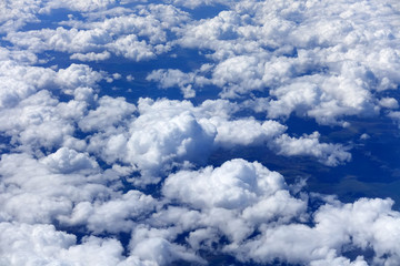 Clouds and sky as seen through window of an aircraft