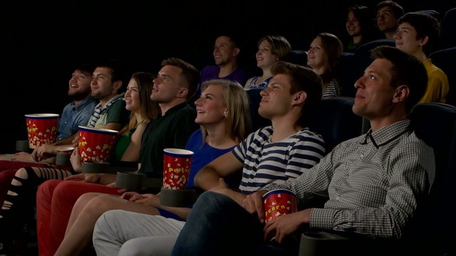 cinema, entertainment and people - happy friends watching movie