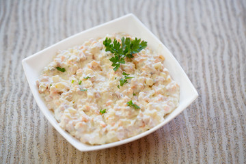 Olivier salad on table/Russian traditional salad Olivier