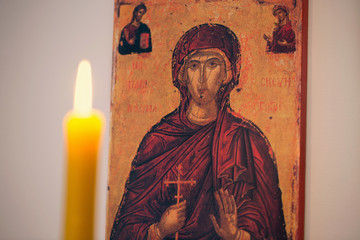 Fototapeta premium Candle light for religious celebration/Picture of Saint