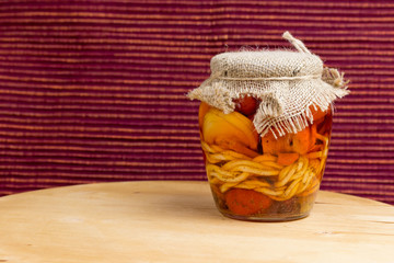 Jar of pickled variety of cheese in oil