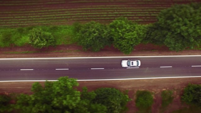 Aerial Of Car Passing By On Small Country Road Rural Countryside