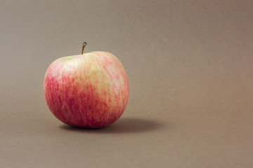 Red apple on a brown background