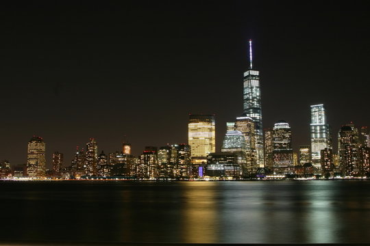 Fototapeta Manhattan night  view with skyscrapers on the right