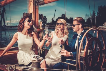 Fototapeta premium Stylish wealthy friends having fun on a luxury yacht