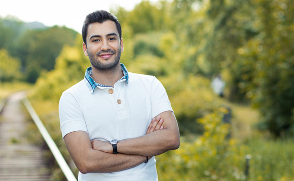 Portait Of A Young Smile Man With Crossed Arms. 