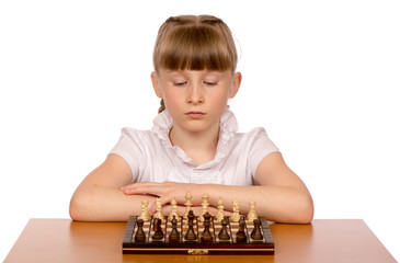A young girl is playing chess.