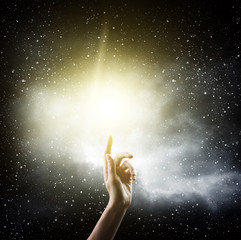 Obraz na płótnie Canvas religion concept. finger touching the magic sky